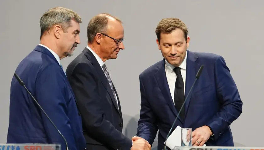 Drei Männer in Anzügen schütteln Hände. Sie repräsentieren Parteien, die überlegen, welche Partei Deutschland regiert.