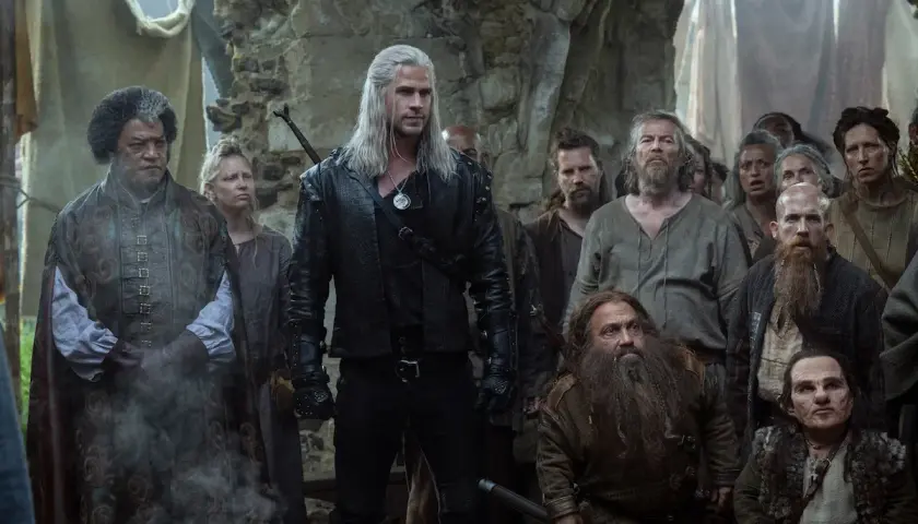 Geralt z Rivii stoi na czele grupy ludzi, krasnoludów i innych istot, czekając na kolejny sezon Wiedźmina.