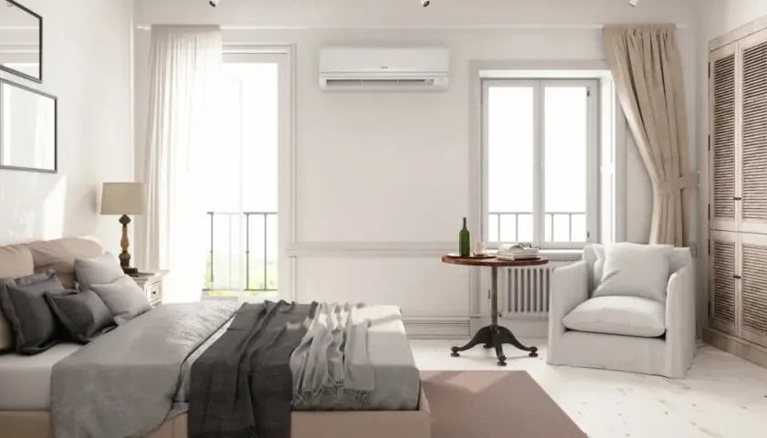 Habitación luminosa con cama, armario y aire acondicionado, ideal para llevar aire acondicionado a otra habitación y disfrutar de confort.