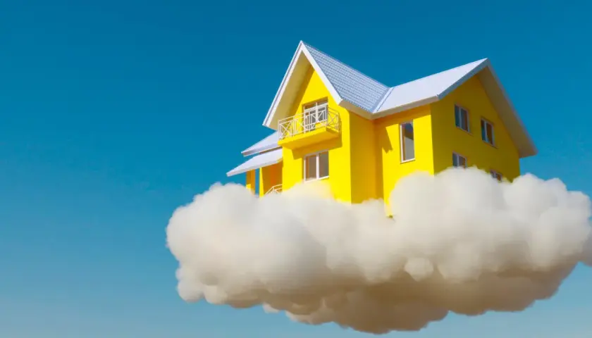 Una casa amarilla con techo blanco flota sobre una nube, como si fuera un sueño con el interior de una casa.