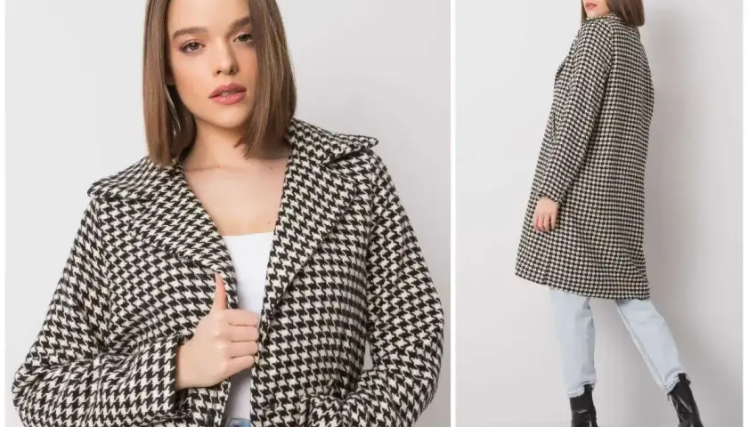 Elegancki płaszcz w klasyczną pepitkę, idealny na jesienne dni. Modelka prezentuje go z jeansami i botkami.