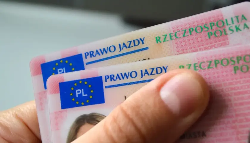 Dwie polskie karty prawa jazdy w dłoni. Dokumenty zawierają flagę UE i napis "Prawo jazdy Rzeczpospolita Polska".