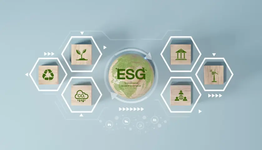Grafika wyjaśniająca, esg co to jest: zielona ziemia z napisem ESG, otoczona ikonami symbolizującymi środowisko, społeczeństwo i ład korporacyjny.