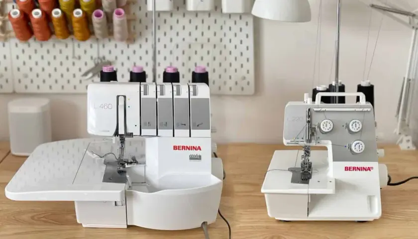 Two Bernina overlock machines, a serger vs overlock comparison, sit on a wooden table.