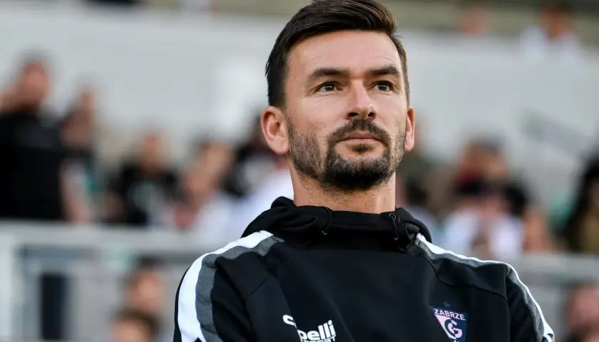 Trener Górnika Zabrze wpatrzony w dal, być może analizuje najnowsze górnik zabrze plotki transferowe.