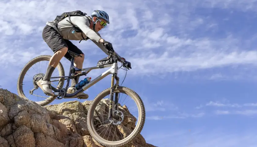 Mountain biker tackling rocky terrain, showcasing the impressive capabilities of the Fox 34 performance review.