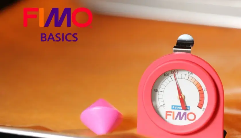 Termómetro FIMO para hornear arcilla. Un trozo de arcilla rosa y un termómetro rojo con la marca FIMO.