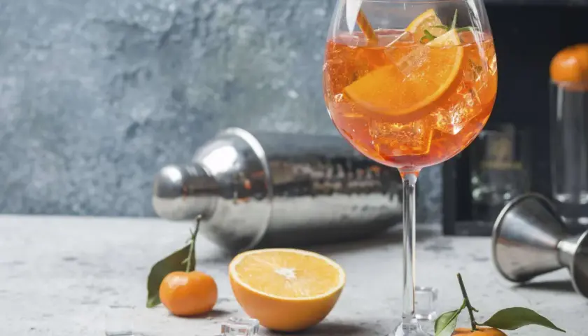 Erfrischender Aperol Spritz mit Orangenscheiben und Eiswürfeln. Die spritz zutaten der iba sind perfekt arrangiert.