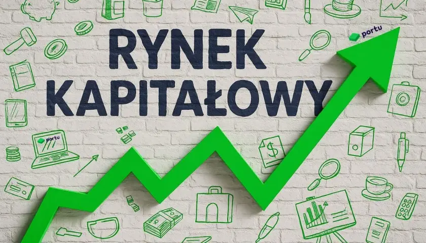 Zielona strzałka rosnąca na tle ceglanego muru z rysunkami symbolizującymi rynek kapitałowy: pieniądze, wykresy, laptop.