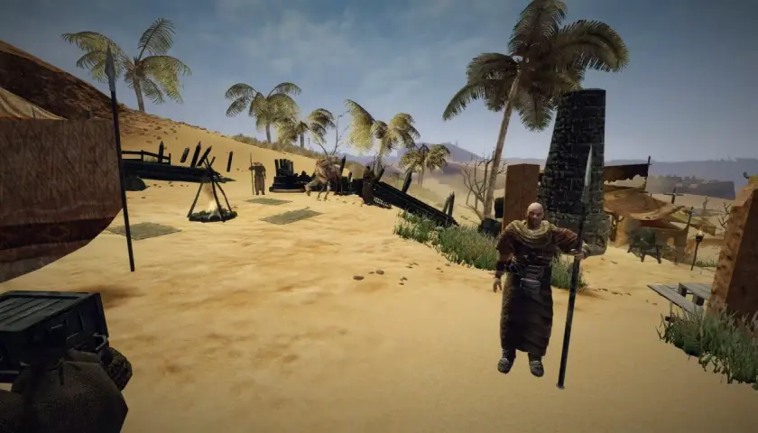 Pustynny obóz w grze Gothic 3, ulepszony przez mody. Postać z włócznią i namioty na piasku.