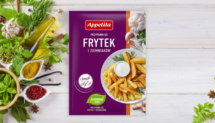 Opakowanie przyprawy do frytek i ziemniaków Appetita z frytkami i dipem na talerzu, otoczone ziołami i przyprawami.
