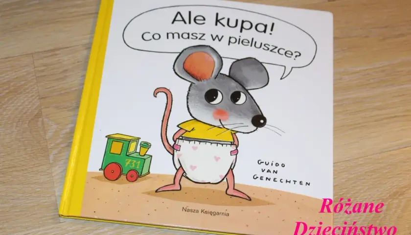 Okładka książki "Ale kupa! Co masz w pieluszce?" z myszką w pieluszce i pociągiem.