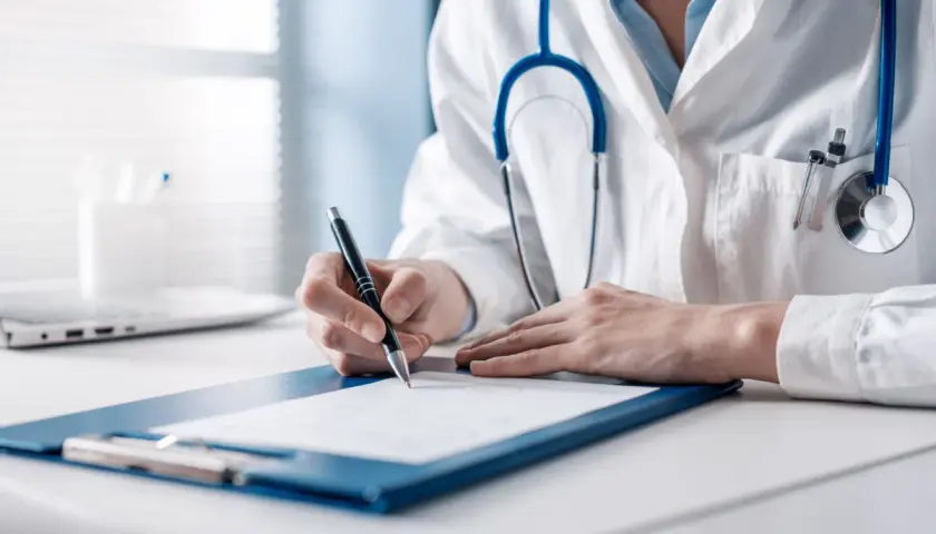 Medico scrive su cartella clinica. Se l'oculista sbaglia, chi paga per l'errore medico?
