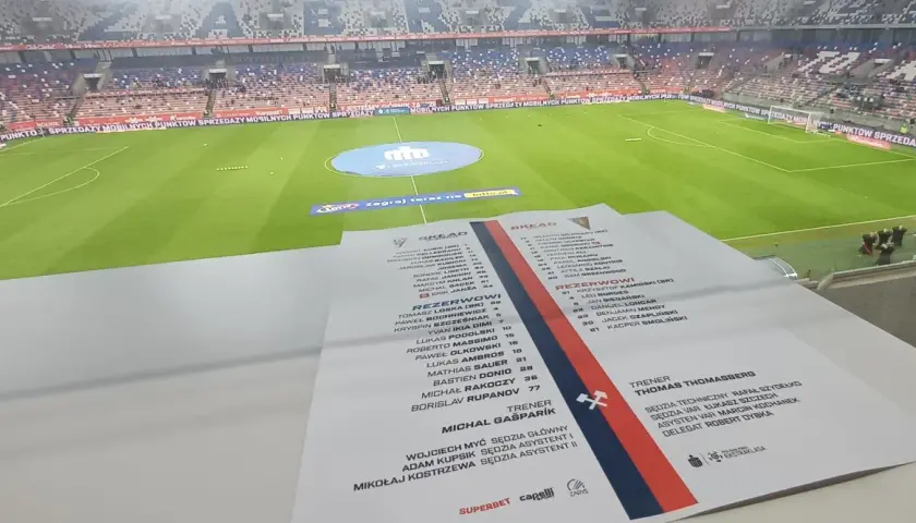 Składy: Pogoń Szczecin – Górnik Zabrze. Na pierwszym planie lista zawodników, w tle stadion.