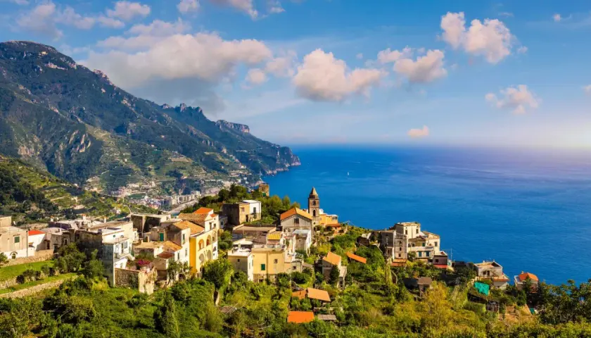Scenic view of Ravello, Italy, perched on a cliff overlooking the sea. Planning how to get from Naples to Ravello? This picturesque town is worth the journey!