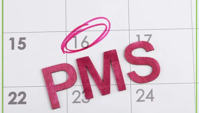 Litery PMS na kalendarzu, dzień 16 zaznaczony kółkiem. Symbolizuje to objawy przed okresem, które mogą pojawić się w tym czasie.