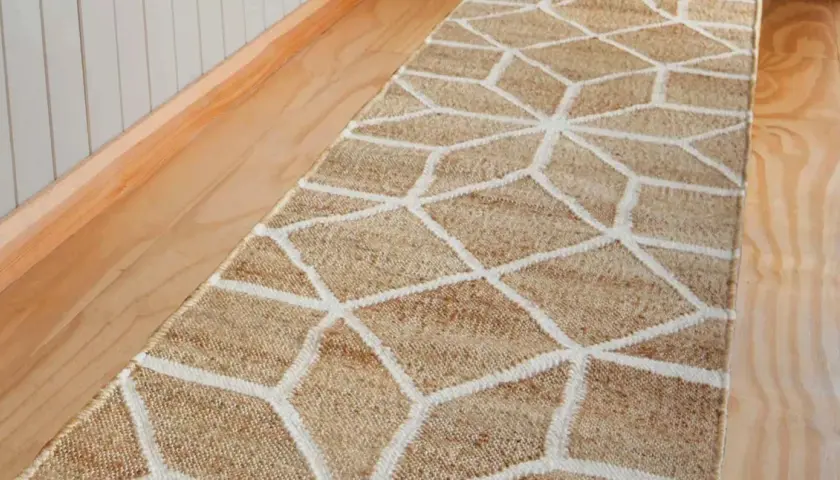 A natural fiber hallway runner with a geometric pattern. This image prompts the question: how long should a hallway runner be to perfectly fit your space?