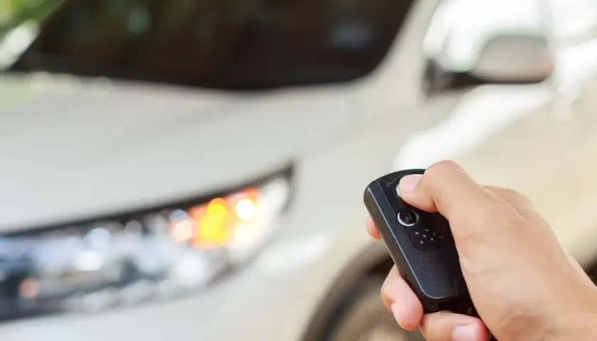 Dłoń trzyma kluczyk do samochodu, gotowa do uruchomienia silnika dzięki funkcji keyless go.