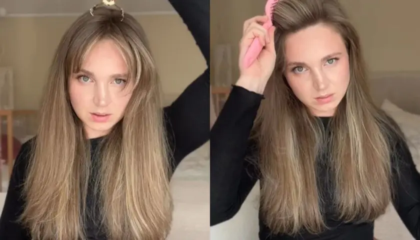 Kobieta z długimi blond włosami używa klipsa i szczotki do nadania objętości.