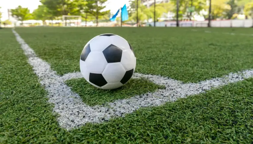 Piłka NFL leży na rogu boiska.
