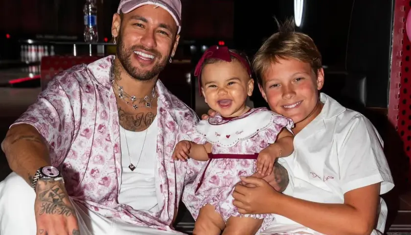 Neymar z synem i córką, wszyscy uśmiechnięci.