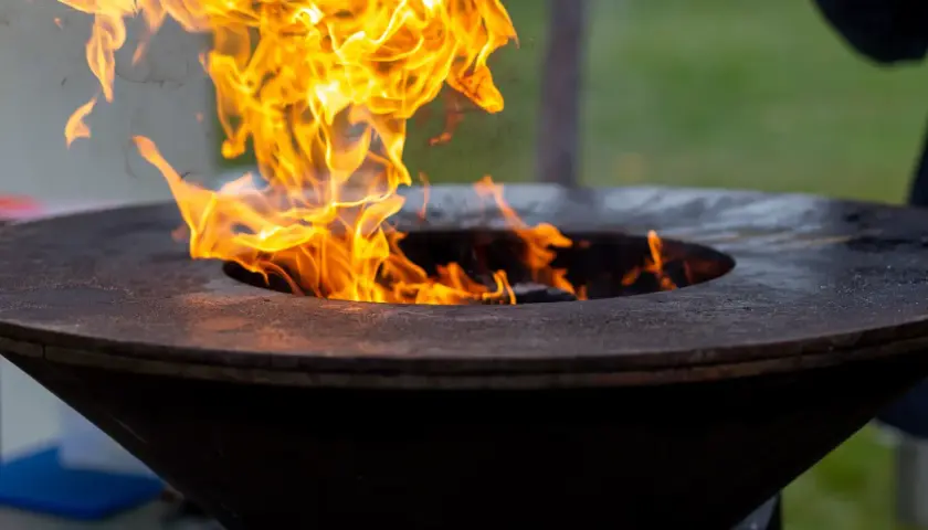 Flammes vives dans un brasero. Pensez à comment nettoyer un brasero après usage pour qu'il reste beau.