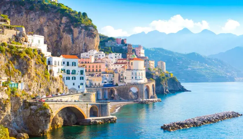 Colorful buildings cling to cliffs overlooking the sea. The Amalfi Coast is safe for exploring this picturesque Italian paradise.
