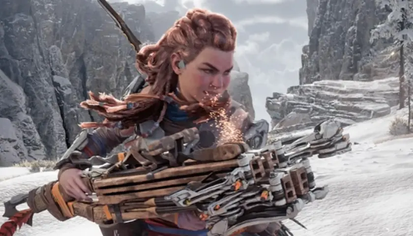 Aloy z Horizon Forbidden West z najlepszą bronią, gotowa do walki w śnieżnym krajobrazie.