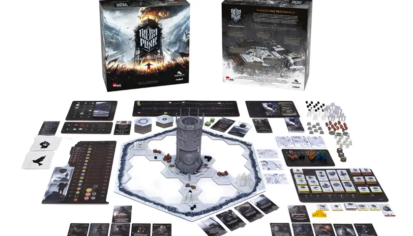Zestaw do gry planszowej Frostpunk: Miasto musi przetrwać. Na stole rozłożona plansza, karty, żetony i wieża generatora.