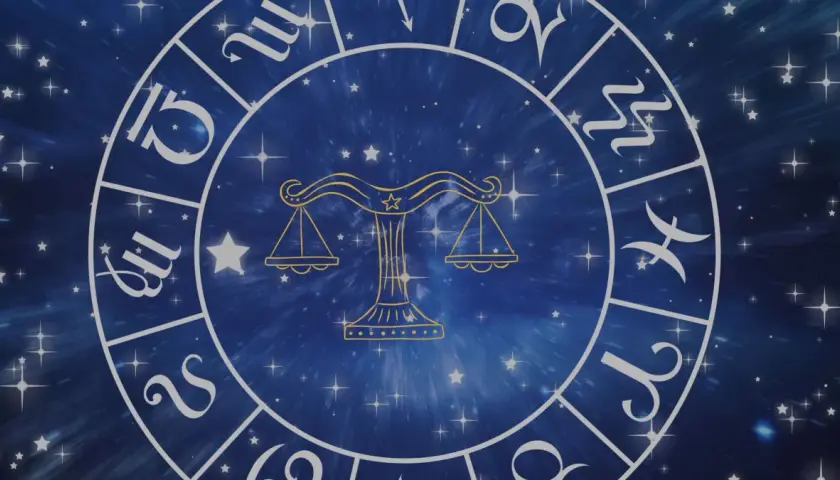 Zodiakalny krąg z wagą pośrodku i symbolami znaków powietrznych na tle gwieździstego nieba.