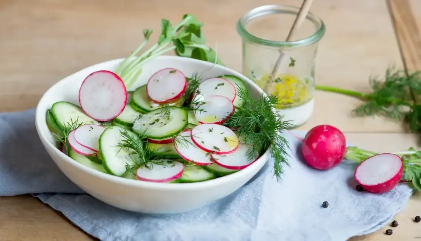Frischer gurke radieschen salat mit Dill und einer leichten Vinaigrette, bereit zum Genießen.