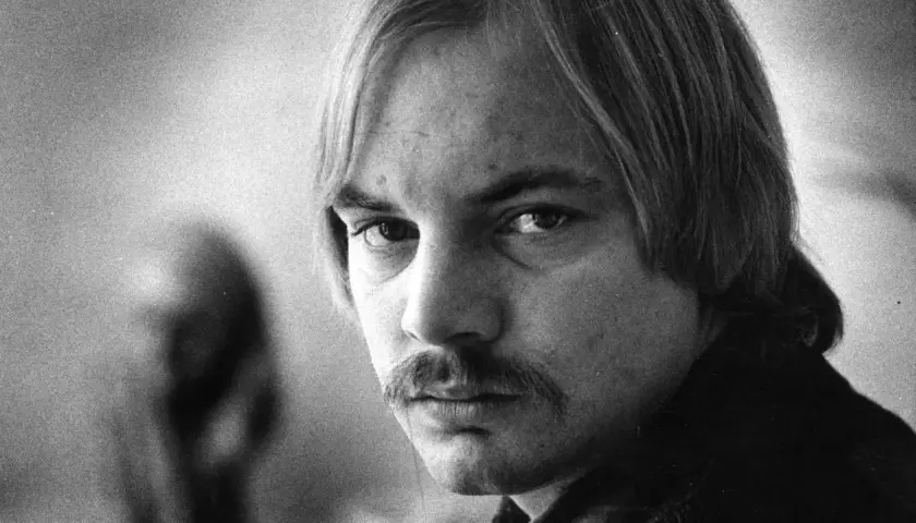 Närbild på en man med mustasch och långt hår. Kanske en ung Lars Norén, eller hans fru?