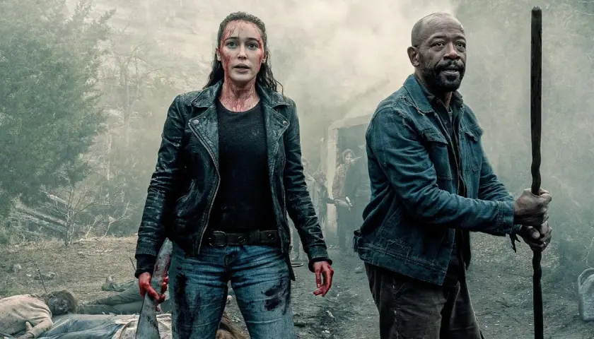 Alicia i Morgan z "Fear the Walking Dead" w otoczeniu dymu i ciał, gotowi do walki.