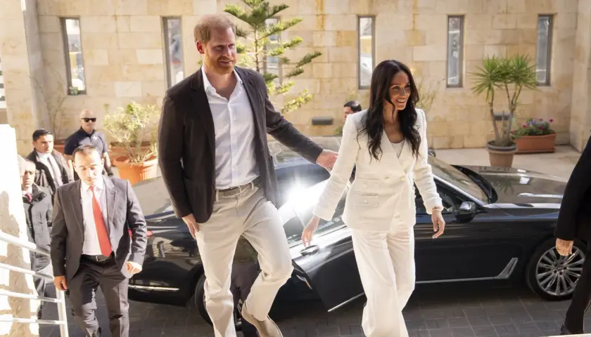 Meghan, duquesa de Sussex, sonríe mientras camina junto al príncipe Harry.