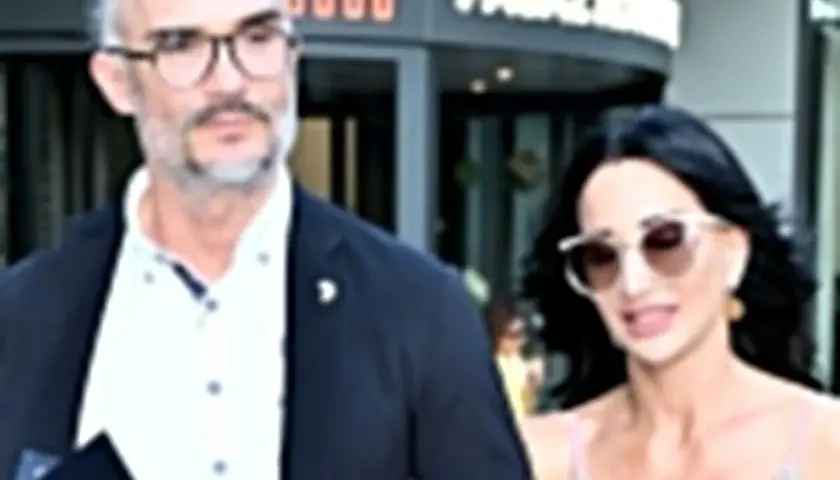 Maciej Myszkowski i jego partnerka, w eleganckich strojach, wychodzą z budynku. Ich wspólne wyjście sugeruje romans.