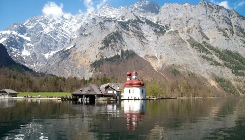 Jezioro Königssee z kościołem św. Bartłomieja i majestatycznymi monachijskimi górami w tle.