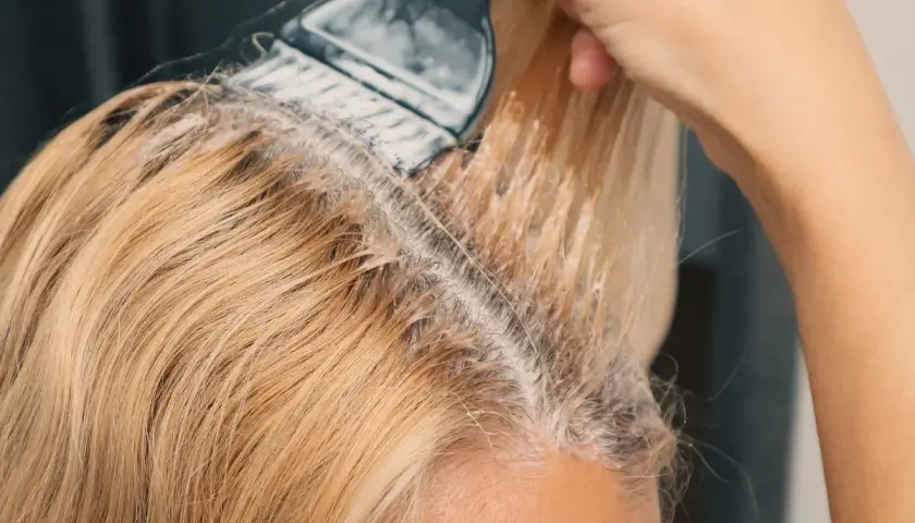 Nakładanie rozjaśniacza na blond włosy. Czekam na naturalne rozjaśnianie włosów efekty.