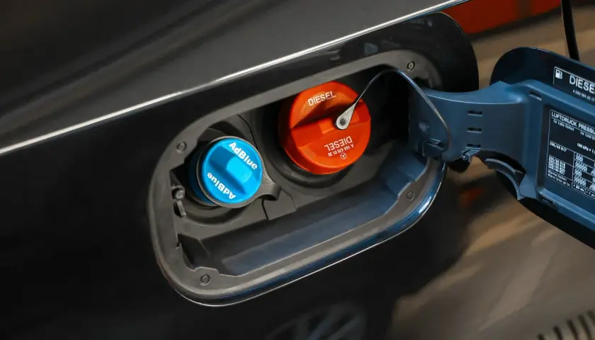 Niebieski korek AdBlue i pomarańczowy korek Diesel w klapce wlewu paliwa. W ten sposób sprawdzisz poziom AdBlue w swoim samochodzie.