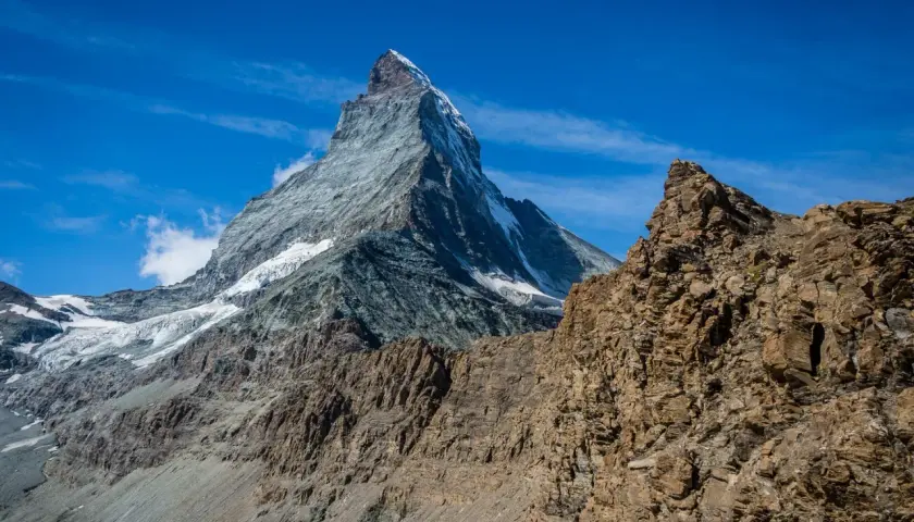 Majestatyczny Matterhorn w słońcu, z lodowcami i skalistymi zboczami. Widok zapierający dech w piersiach, jakbyś stał u progu wejścia na Matterhorn.