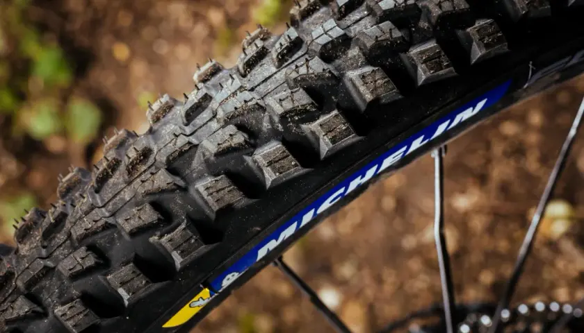 Close-up of a rugged Michelin Force AM2 tire, ready to grip the trail.