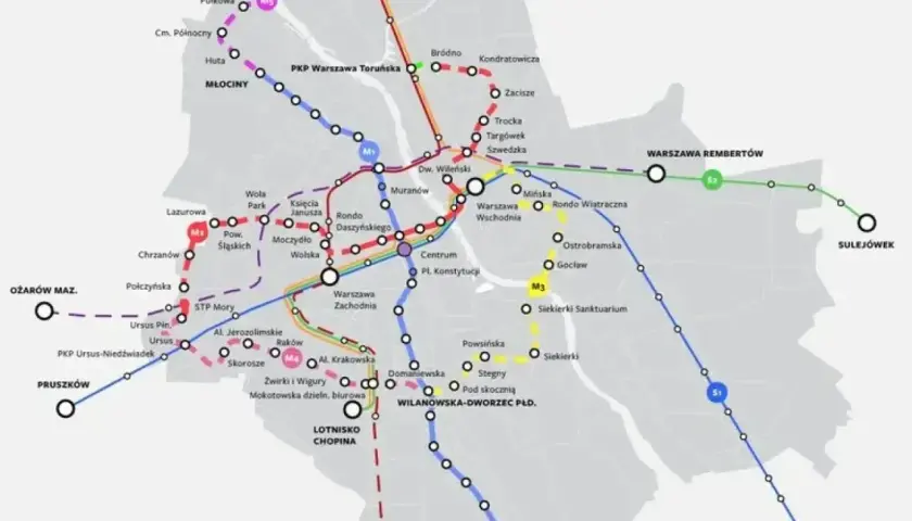 Mapa pokazuje stacje metra M2 i inne linie kolejowe w Warszawie, z zaznaczonymi węzłami przesiadkowymi i nazwami przystanków.