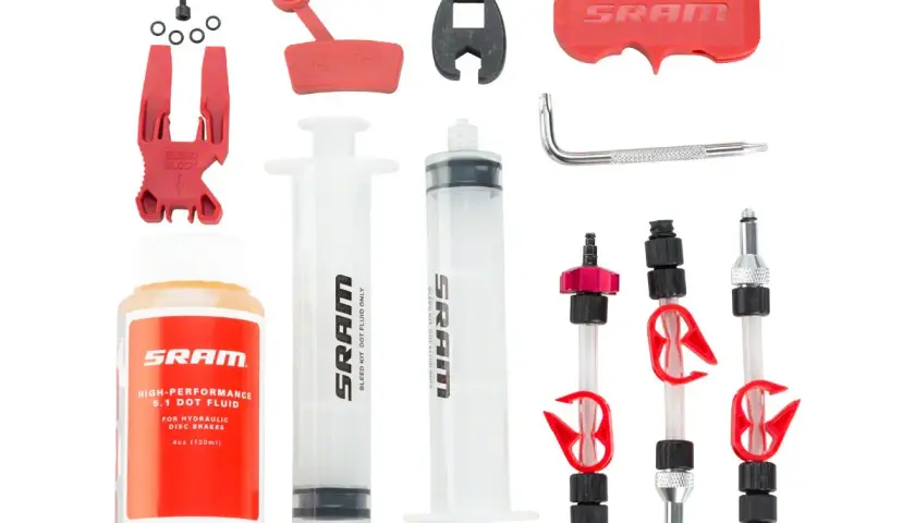 SRAM brake bleed kit with syringes, fluid, bleed block, and adapters.