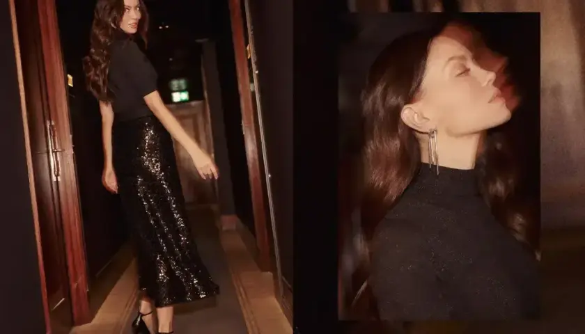 Elegancka stylizacja do opery: czarna bluzka z golfem i błyszcząca spódnica midi. Idealna na wieczorne wyjście.