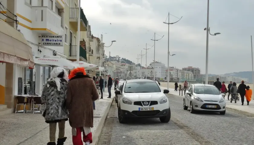 Dwie osoby w kostiumach idą ulicą nadmorskiego miasteczka. Podróżowanie jako sposób na poznanie świata i samego siebie, nawet w tak nietypowej formie.