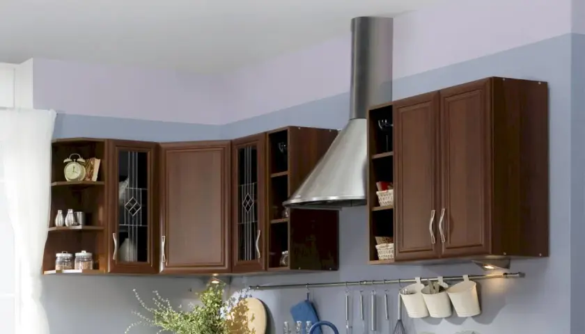 Inspiracja do tego, jak pomalować kuchnię z brązowymi meblami: pastelowe ściany i nowoczesny okap nadają ciepły, przytulny klimat.