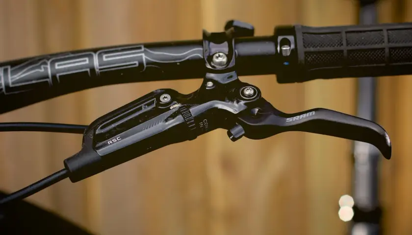 Close-up of a black SRAM Guide RSC brakes lever on a bicycle handlebar.