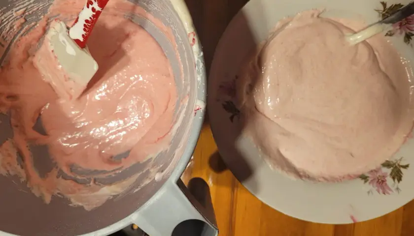 Różowa masa na makaroniki w misce i na talerzu. Ania gotuje, przygotowując ten słodki deser.