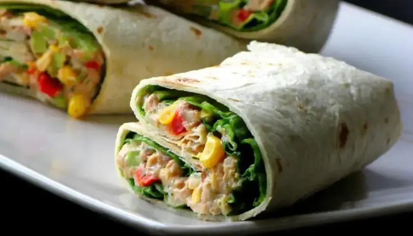 Pyszna tortilla z tuńczykiem, chrupiącą sałatą, kukurydzą i papryką. Idealna na szybki lunch.