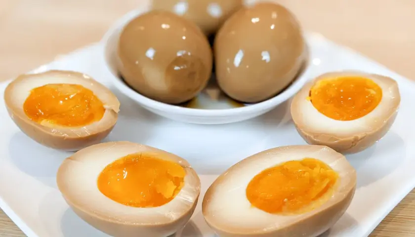 Oeufs marinés pour ramen, avec des jaunes coulants et une saveur riche. Parfaits pour garnir votre bol de nouilles.