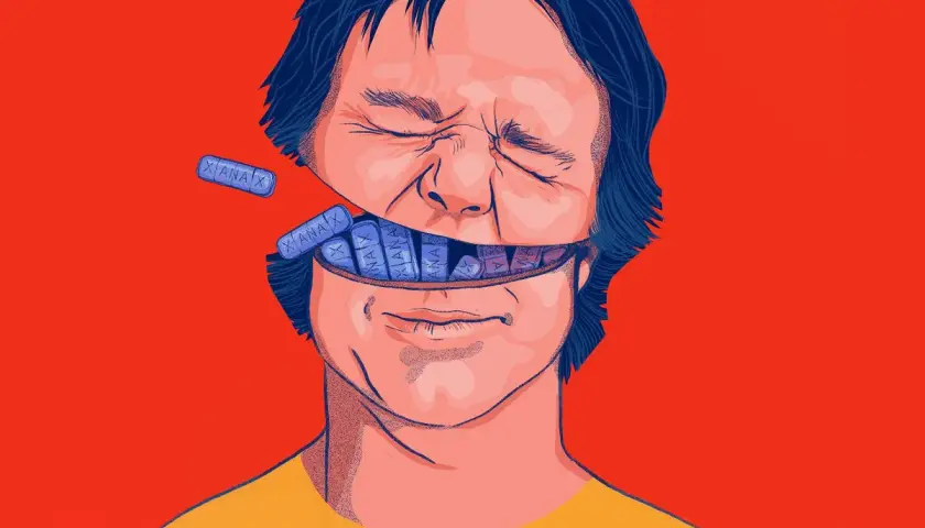 Otwarta głowa mężczyzny wypełniona tabletkami Xanax. Ilustracja przedstawia potencjalne xanax skutki uboczne.